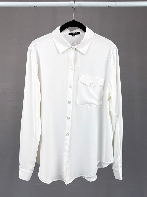 White shirt on a hanger against a gray background