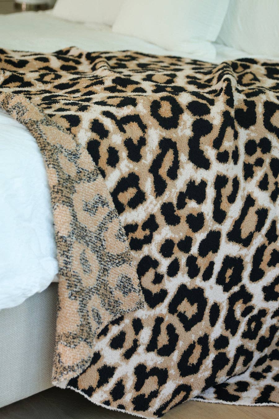 Leopard print blanket draped over a bed