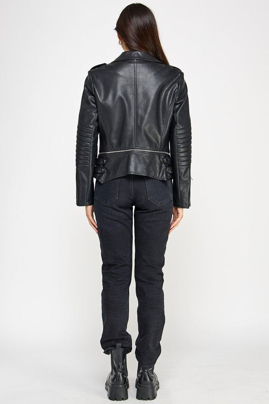 Person wearing a black leather jacket and pants on a white background