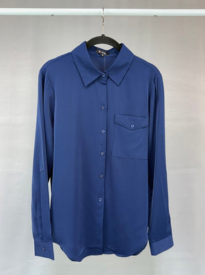 Blue shirt on a hanger against a plain background