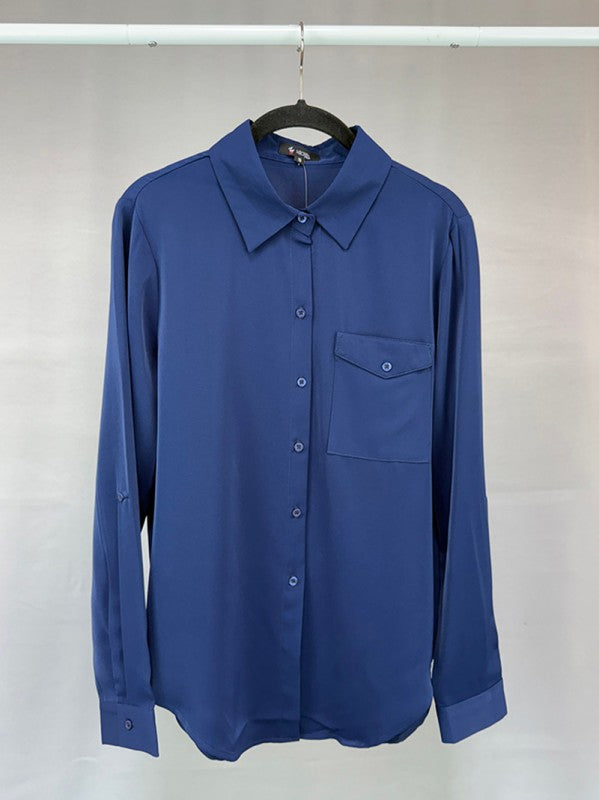 Blue shirt on a hanger against a plain background