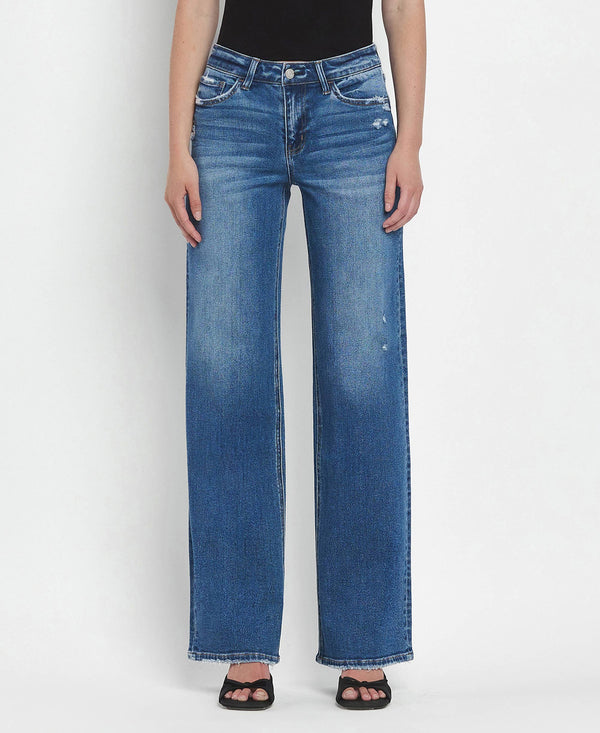 Person wearing blue jeans on a white background