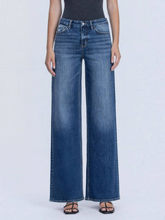 Person wearing blue wide-leg jeans on a white background