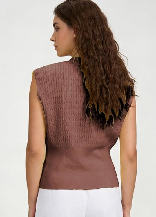 Woman wearing a brown textured sleeveless top against a white background
