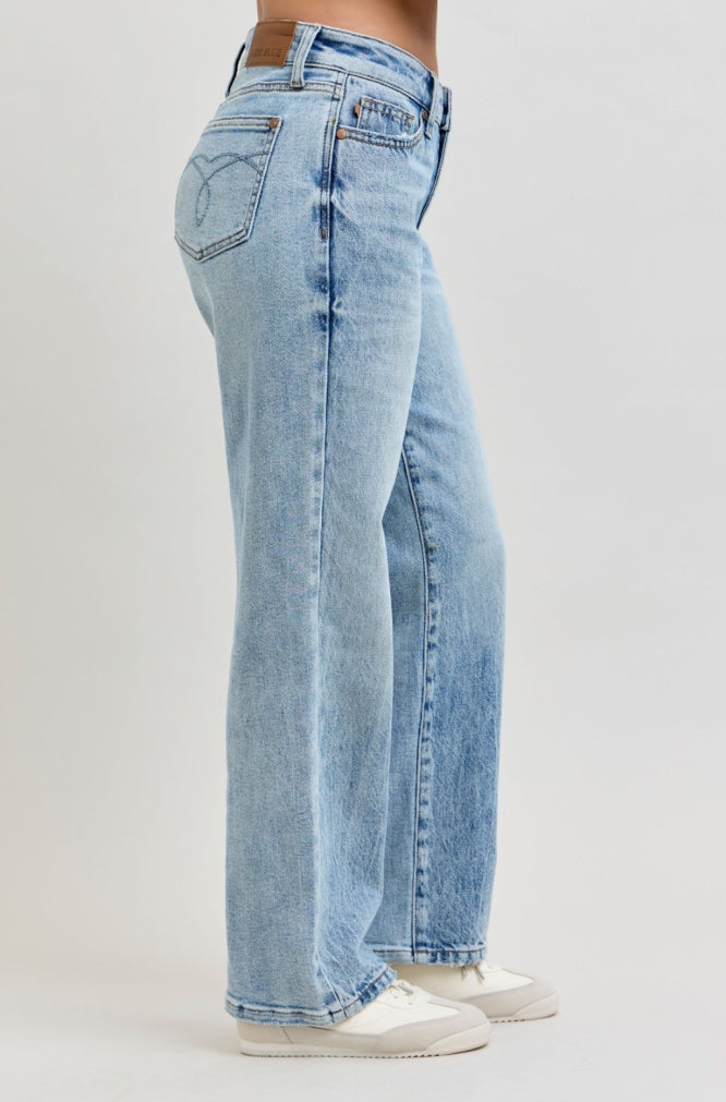 Light blue jeans worn by a person on a white background