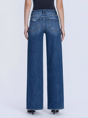 Blue jeans worn by a person on a white background
