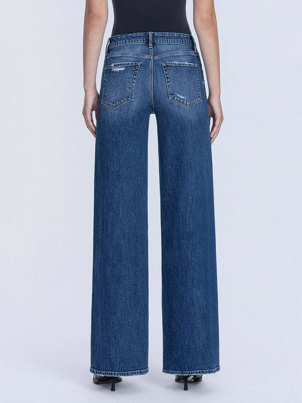 Blue jeans worn by a person on a white background