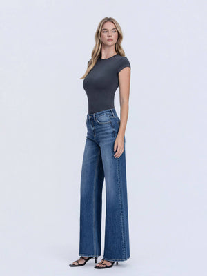 Woman wearing a black t-shirt and blue jeans on a white background